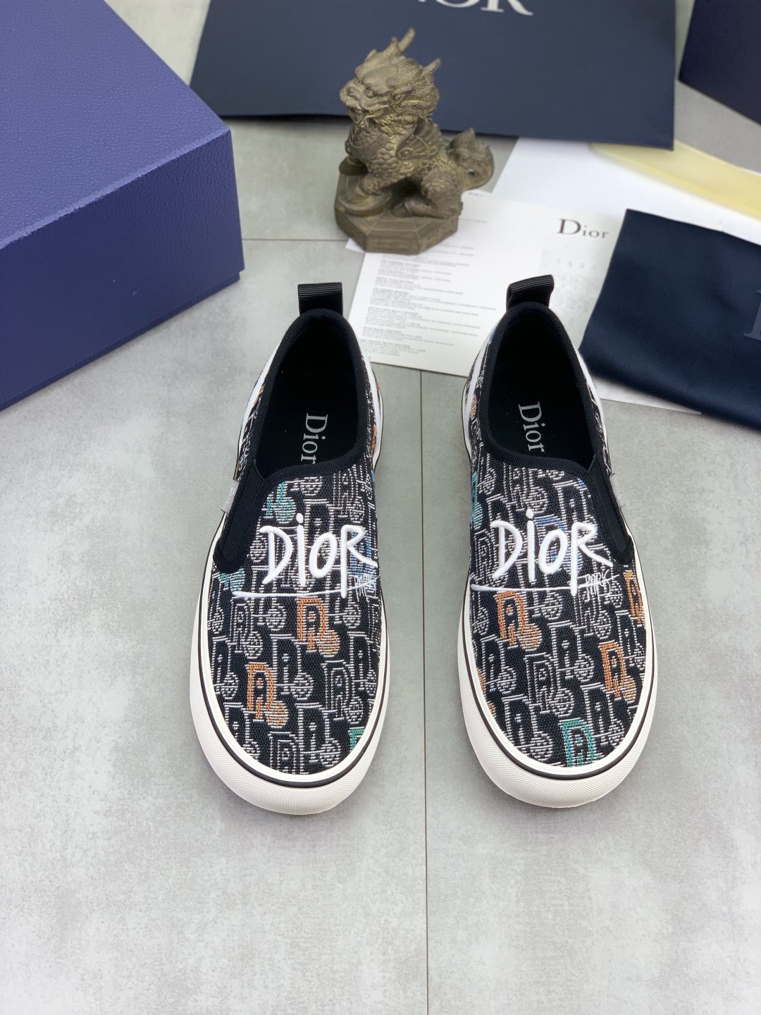 Dior Graphic Canvas Slip-On Sneakers - Black, White and Tan
